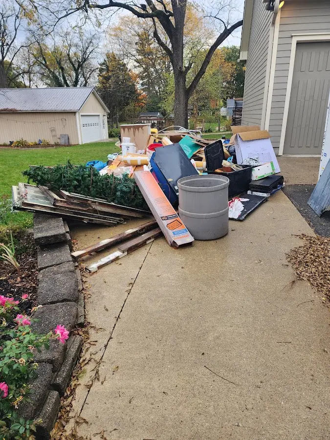 Dumpster being loaded with debris for 10 Yard Dumpster Rental in Veneta